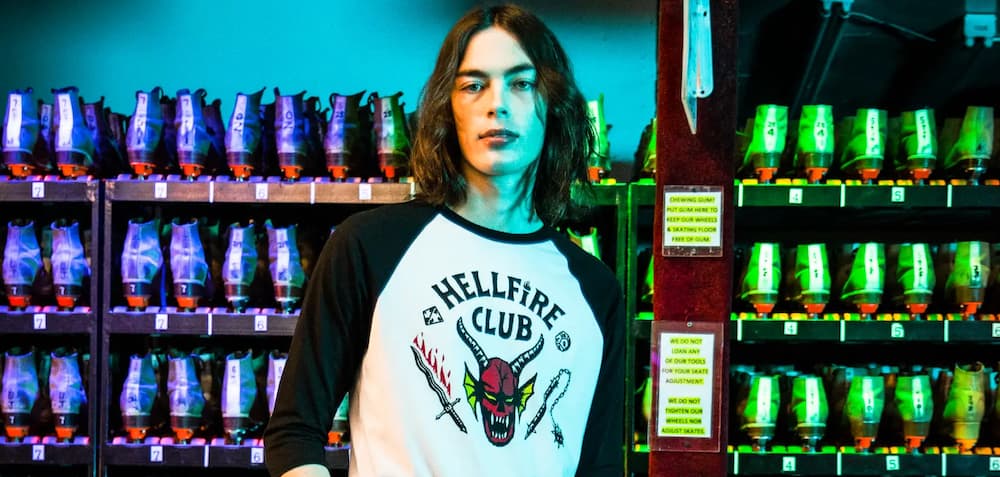 A person wearing Hot Topic's Hellfire Club t-shirt